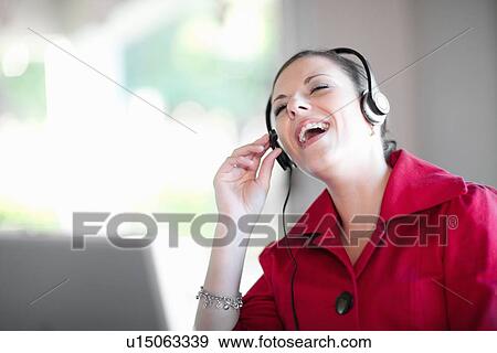 Businesswoman talking on headset View Large Photo Image Stock Photo - Businesswoman talking on headset. Fotosearch