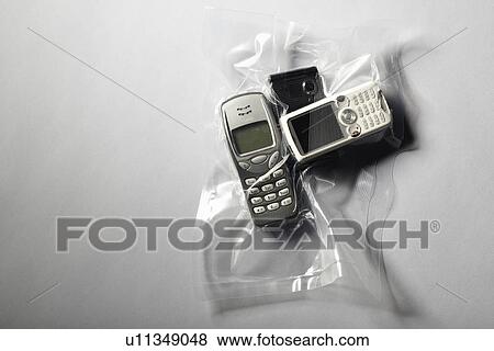 Stock Photo - Cell phones shrink wrapped in plastic. Fotosearch