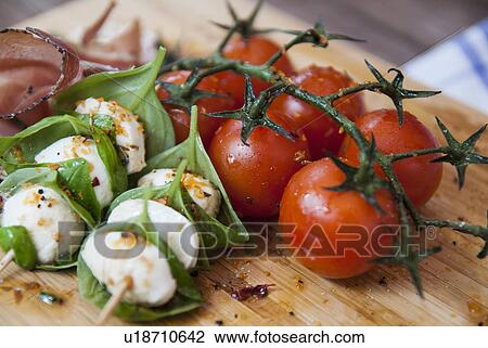 Stock Image - Cheese with herbs and tomato. Fotosearch