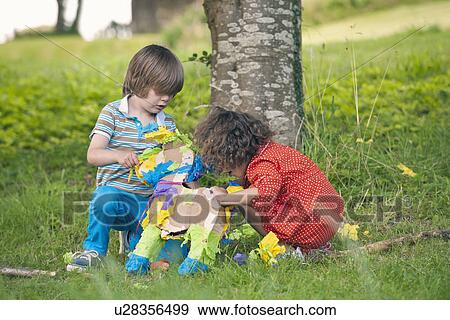 Children opening pinata at party View Large Photo Image Stock Photo - Children opening pinata at party. Fotosearch
