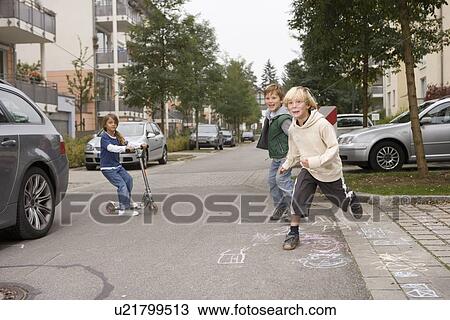 Children playing on suburban street View Large Photo Image Stock Image - Children playing on suburban street. Fotosearch