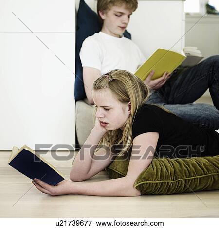 Stock Photo - Children reading in living room. Fotosearch
