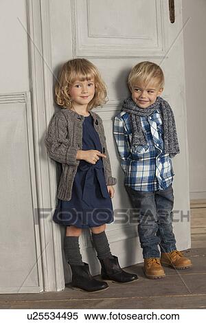 Stock Photography - Children smiling together indoors. Fotosearch