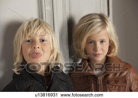 Stock Image - Children wearing winter coats indoors. Fotosearch