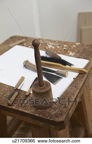 Stock Photograph - Chisel tools and paper on wooden board. Fotosearch
