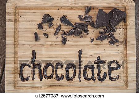 Chocolate written on cutting board View Large Photo Image Stock Photo - Chocolate written on cutting board. Fotosearch