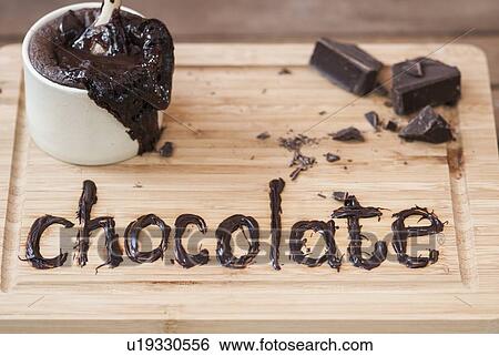Stock Photograph - Chocolate written on cutting board. Fotosearch