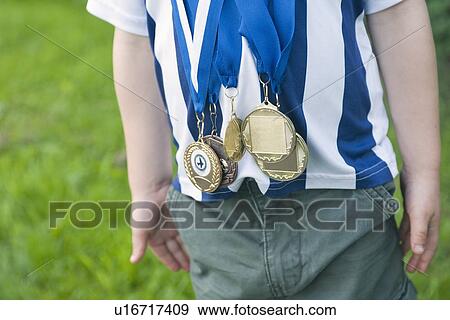 Stock Photo - Close up of boy wearing medals. Fotosearch
