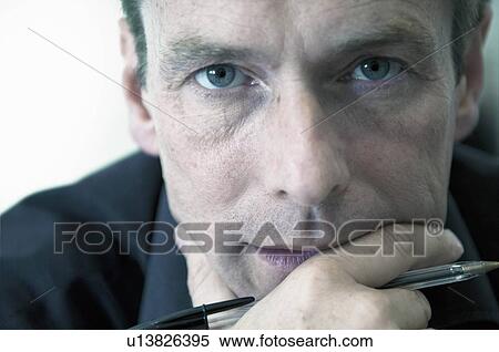 Close up of businessmans serious face View Large Photo Image Stock Photography - Close up of businessmans serious face. Fotosearch