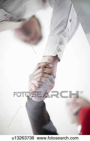 Close up of businessmen shaking hands View Large Photo Image Stock Photograph - Close up of businessmen shaking hands. Fotosearch