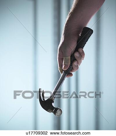 Close up of hand holding hammer View Large Photo Image Stock Image - Close up of hand holding hammer. Fotosearch