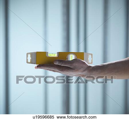 Close up of hand holding level View Large Photo Image Stock Photography - Close up of hand holding level. Fotosearch