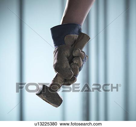 Close up of hand holding mallet View Large Photo Image Stock Image - Close up of hand holding mallet. Fotosearch