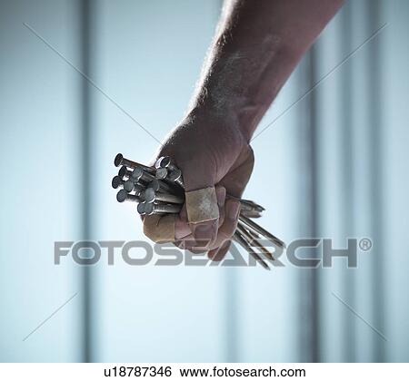 Close up of hand holding nails View Large Photo Image Stock Photograph - Close up of hand holding nails. Fotosearch