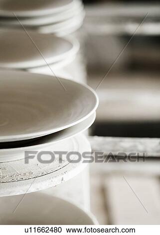 Stock Image - Close up of handcrafted ceramics in shop. Fotosearch