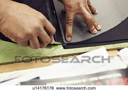 Close up of hands cutting leather View Large Photo Image Stock Photo - Close up of hands cutting leather. Fotosearch
