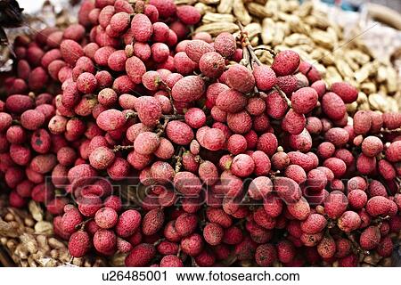 Stock Image - Close up of pile of lychee fruit. Fotosearch