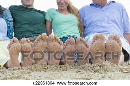 Close up of sandy feet on beach View Large Photo Image Picture - Close up of sandy feet on beach. Fotosearch