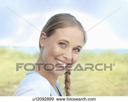 Stock Photo - Close up of smiling womans face. Fotosearch