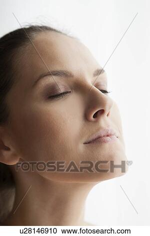 Stock Image - Close up of womans smiling face. Fotosearch