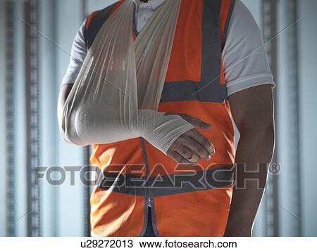 Stock Image - Close up of worker with arm in sling. Fotosearch