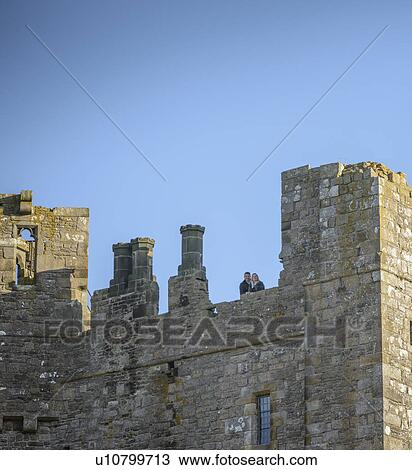 Stock Image - Couple overlooking view from castle. Fotosearch