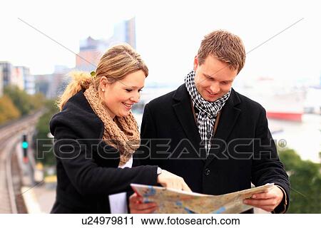 Stock Image - Couple reading city map. Fotosearch