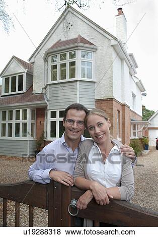 Couple smiling outside house View Large Photo Image Stock Photo - Couple smiling outside house. Fotosearch