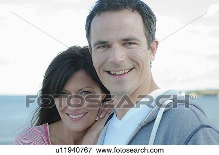 Stock Photo - Couple smiling together outdoors. Fotosearch