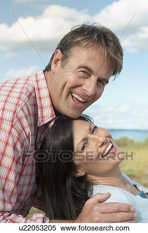 Couple smiling together outdoors View Large Photo Image Stock Photography - Couple smiling together outdoors. Fotosearch