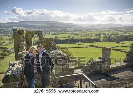 Couple standing on medieval ruins View Large Photo Image Stock Photograph - Couple standing on medieval ruins. Fotosearch