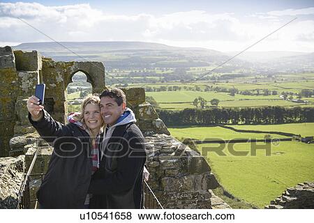 Stock Photo - Couple taking picture on medieval ruins. Fotosearch