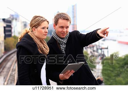 Couple using tablet computer outdoors View Large Photo Image Stock Image - Couple using tablet computer outdoors. Fotosearch