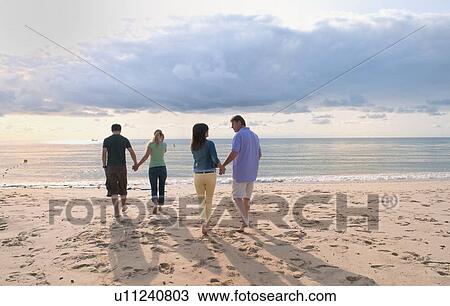 Couples holding hands on beach View Large Photo Image Stock Image - Couples holding hands on beach. Fotosearch