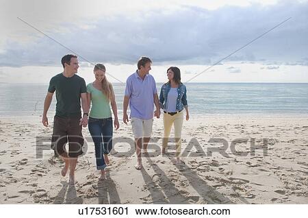Couples holding hands on beach View Large Photo Image Stock Image - Couples holding hands on beach. Fotosearch