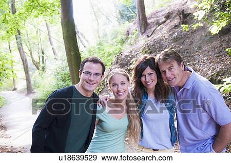 Couples smiling together in forest View Large Photo Image Stock Photo - Couples smiling together in forest. Fotosearch