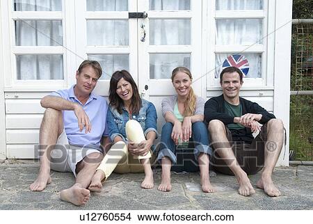 Couples smiling together outside house View Large Photo Image Picture - Couples smiling together outside house. Fotosearch