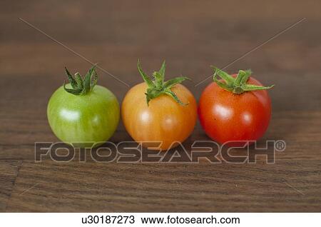 Different colored tomatoes on table View Large Photo Image Stock Image - Different colored tomatoes on table. Fotosearch