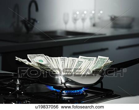 Dollar bills in frying pan on stove View Large Photo Image Stock Photograph - Dollar bills in frying pan on stove. Fotosearch