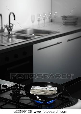 Dollar bills on cutting board in kitchen View Large Photo Image Stock Photograph - Dollar bills on cutting board in kitchen. Fotosearch