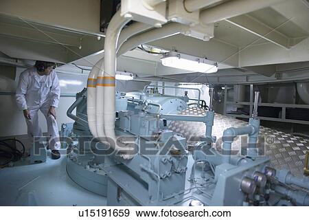 Engineer working in ships engine room View Large Photo Image Stock Photo - Engineer working in ships engine room. Fotosearch