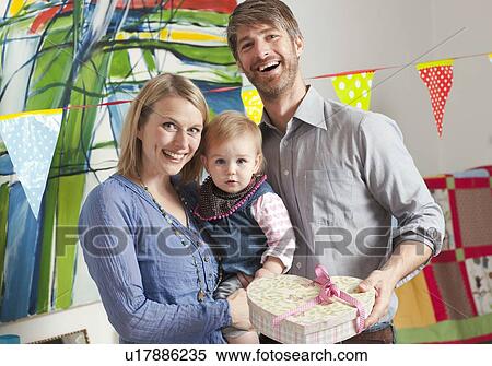 Family holding heart shaped box View Large Photo Image Stock Photography - Family holding heart shaped box. Fotosearch