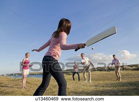 Family playing cricket together outdoors View Large Photo Image Stock Photo - Family playing cricket together outdoors. Fotosearch