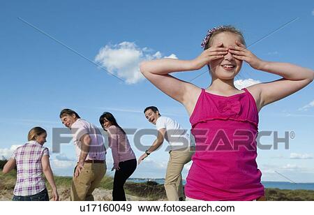 Family playing hide and seek outdoors View Large Photo Image Stock Photo - Family playing hide and seek outdoors. Fotosearch