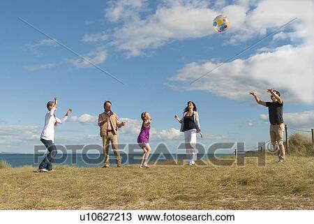Stock Image - Family playing together outdoors. Fotosearch