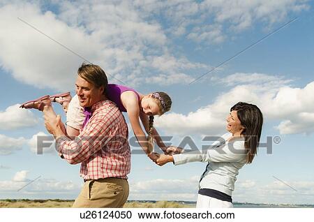 Family playing together outdoors View Large Photo Image Stock Image - Family playing together outdoors. Fotosearch