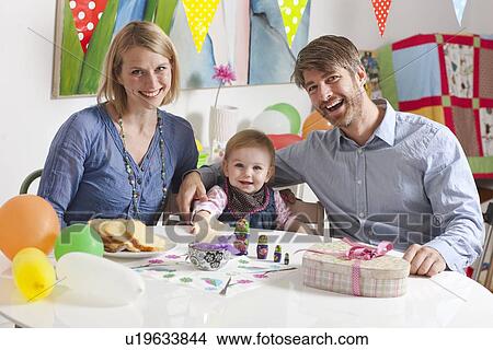 Family sitting at breakfast table View Large Photo Image Picture - Family sitting at breakfast table. Fotosearch