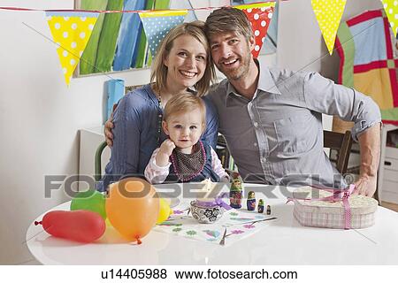 Family sitting at breakfast table View Large Photo Image Stock Photo - Family sitting at breakfast table. Fotosearch