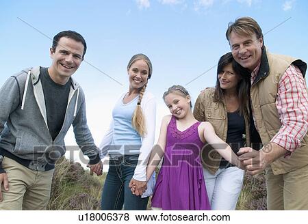 Stock Photo - Family smiling together outdoors. Fotosearch