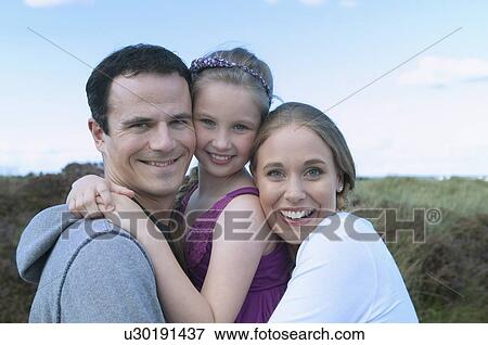 Family smiling together outdoors View Large Photo Image Stock Photo - Family smiling together outdoors. Fotosearch